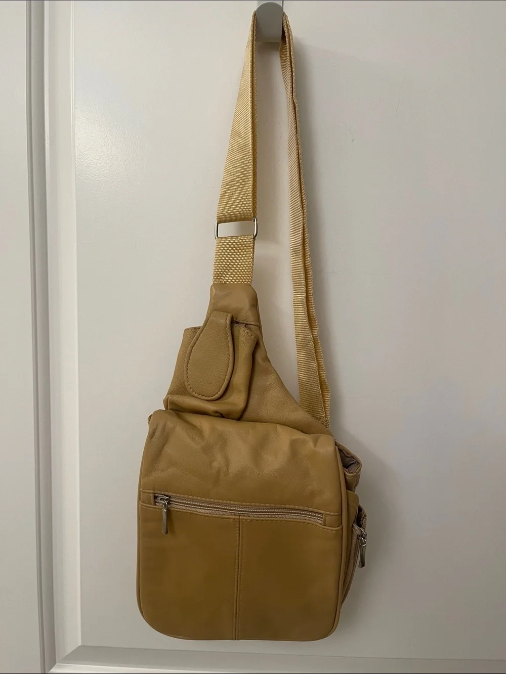 Buxton tan crossbody sling backpack